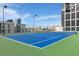 A stunning rooftop tennis court with green and blue surface offers an amazing outdoor recreational opportunity at 1280 W Peachtree St Nw, Unit 3414, Atlanta, GA 30309