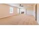 Bright bedroom featuring neutral carpeting, a ceiling fan, and multiple windows for natural light at 204 Crabapple Rd, Mcdonough, GA 30253