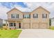 Spacious two-story home with a brick facade, three-car garage, and manicured front lawn at 204 Crabapple Rd, Mcdonough, GA 30253