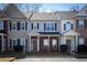 Inviting townhome exterior with brick accents, covered porch, and manicured landscaping at 902 Tree Creek Blvd # 2, Lawrenceville, GA 30043