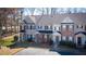 Well-maintained townhomes featuring varied architectural details and lush green spaces at 902 Tree Creek Blvd # 2, Lawrenceville, GA 30043