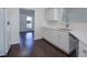 Bright kitchen with stainless steel dishwasher, white cabinets, hardwood floors and white countertops at 902 Tree Creek Blvd # 2, Lawrenceville, GA 30043