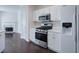 Well-lit kitchen with stainless steel appliances, white cabinets and hardwood floors at 902 Tree Creek Blvd # 2, Lawrenceville, GA 30043