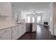 Bright kitchen with stainless steel dishwasher, white cabinets, hardwood floors, fireplace and white countertops at 902 Tree Creek Blvd # 2, Lawrenceville, GA 30043
