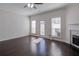 Bright living room featuring hardwood floors, a fireplace, and outdoor access at 902 Tree Creek Blvd # 2, Lawrenceville, GA 30043