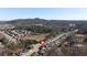 Aerial view showing the house nestled in a picturesque neighborhood near a pond and scenic mountain views at 138 Lakestone Pkwy, Woodstock, GA 30188