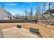 A large, well-maintained backyard featuring a patio, a swing set, and a beautiful view of the surrounding landscape at 138 Lakestone Pkwy, Woodstock, GA 30188