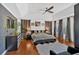 Primary bedroom with tray ceiling, hardwood floors, and designer wallpaper that adds an element of luxury at 138 Lakestone Pkwy, Woodstock, GA 30188