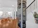 Bright foyer features a modern glass elevator, hardwood floors, and a view of the formal dining area at 138 Lakestone Pkwy, Woodstock, GA 30188
