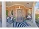 Charming front porch with seating, decor, and inviting entrance at 138 Lakestone Pkwy, Woodstock, GA 30188