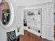 Charming hallway with a decorative window, stylish bench, and built-in shelving, adding character to the home at 138 Lakestone Pkwy, Woodstock, GA 30188