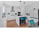 Well-lit kitchen showcasing white cabinets, a kitchen island, and stainless steel appliances for an updated look at 138 Lakestone Pkwy, Woodstock, GA 30188