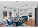 Bright kitchen features stainless steel appliances, white cabinetry, and an island with bar seating for a modern touch at 138 Lakestone Pkwy, Woodstock, GA 30188