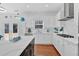 Bright kitchen featuring white cabinets, stainless steel appliances, and a view to the backyard, blending style with functionality at 138 Lakestone Pkwy, Woodstock, GA 30188