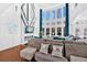 Bright living room featuring a fireplace, large windows, and modern decor at 138 Lakestone Pkwy, Woodstock, GA 30188