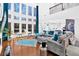 Open-concept living room with soaring windows, hardwood floors, and stylish furnishings at 138 Lakestone Pkwy, Woodstock, GA 30188