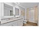 Bright bathroom with double vanity, granite countertop, framed mirror, and bathtub with shower at 654 Egrets Lndg, Covington, GA 30014