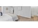 Bedroom with light gray walls and carpet, walk in closet, and a peek into the hallway at 654 Egrets Lndg, Covington, GA 30014