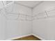 Walk-in closet with standard wire shelving system, neutral colors and carpeted floor at 654 Egrets Lndg, Covington, GA 30014
