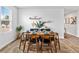 Dining area is brightly lit with a view through the window and modern decor at 654 Egrets Lndg, Covington, GA 30014