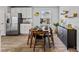 Bright dining area features seating for six, wood flooring, and modern decor at 654 Egrets Lndg, Covington, GA 30014