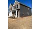 Side view of a two-story home featuring brick and dark siding at 654 Egrets Lndg, Covington, GA 30014