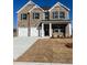 Two-story brick home featuring a two-car garage and a covered porch at 654 Egrets Lndg, Covington, GA 30014