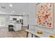 Open-concept living room with a view of a stylish kitchen and an artistic painting at 654 Egrets Lndg, Covington, GA 30014