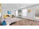 Open-concept living room boasts wood flooring, a fireplace, and bright, airy windows at 654 Egrets Lndg, Covington, GA 30014