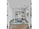 Stylish home office with desk, chair, shelving, and natural light at 654 Egrets Lndg, Covington, GA 30014