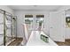 Bright home office featuring wood flooring, large windows and stylish shelving at 654 Egrets Lndg, Covington, GA 30014