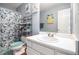 Cozy bathroom with a white vanity, floral shower curtain, and storage shelving for an organized space at 7865 Lake Ter, Douglasville, GA 30134