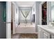 Bathroom featuring a soaking tub and a closet, providing a serene bathing experience at 7865 Lake Ter, Douglasville, GA 30134