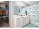 Bathroom with double sink vanity, ample storage, and a dolphin-themed shower curtain at 7865 Lake Ter, Douglasville, GA 30134