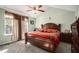 Spacious bedroom with a large bed, neutral carpet, and bright natural light at 7865 Lake Ter, Douglasville, GA 30134