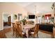 Open-concept dining area with hardwood floors that flows into the living room with a fireplace at 7865 Lake Ter, Douglasville, GA 30134