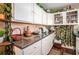 Kitchen with white cabinets, dark countertops, and decor elements creating a welcoming atmosphere at 7865 Lake Ter, Douglasville, GA 30134