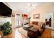 Cozy living room with fireplace, ceiling fan and comfortable sectional sofa on hardwood floors at 7865 Lake Ter, Douglasville, GA 30134