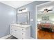 Charming blue bathroom featuring a white vanity and view to the adjacent bedroom at 1026 Saint Charles Ne Ave # 10, Atlanta, GA 30306