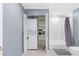 Bathroom closet with stacked washer and dryer, shelving, and storage space at 1026 Saint Charles Ne Ave # 10, Atlanta, GA 30306