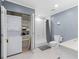 Bathroom closet with stacked washer and dryer, shelving, and storage space at 1026 Saint Charles Ne Ave # 10, Atlanta, GA 30306