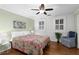 Bright bedroom with hardwood floors, white brick wall, and colorful patterned bedspread at 1026 Saint Charles Ne Ave # 10, Atlanta, GA 30306