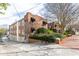 A brick building with mature trees, landscaping and well-maintained brick sidewalk adds to the curb appeal at 1026 Saint Charles Ne Ave # 10, Atlanta, GA 30306