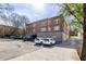 Brick apartment building featuring on-site parking for residents and guests under a partly cloudy sky at 1026 Saint Charles Ne Ave # 10, Atlanta, GA 30306