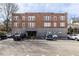 Exterior of a well-maintained brick apartment building with ample parking space available at 1026 Saint Charles Ne Ave # 10, Atlanta, GA 30306