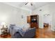 Cozy living room featuring hardwood floors, a stylish sofa, and a television at 1026 Saint Charles Ne Ave # 10, Atlanta, GA 30306