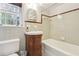 This bathroom features tiled walls, a white bathtub, and a wooden vanity with drawers at 1031 Lindridge Ne Dr, Atlanta, GA 30324