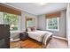 Bedroom with hardwood floors, neutral walls, and natural lighting from two windows at 1031 Lindridge Ne Dr, Atlanta, GA 30324