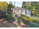 Exterior view of the house shows a wooden deck and lush greenery at 1031 Lindridge Ne Dr, Atlanta, GA 30324
