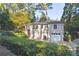 Exterior view of the house shows a wooden deck, garage, and lush greenery at 1031 Lindridge Ne Dr, Atlanta, GA 30324